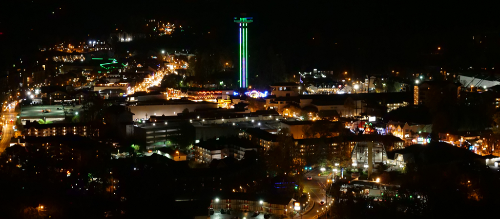 Aerial view of downtown Gatlinburg at night, with tons of city lights.