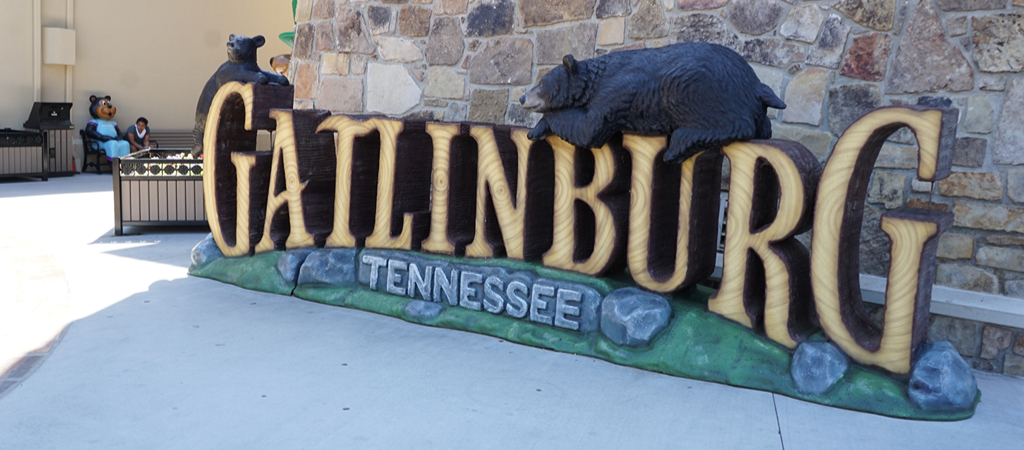 A downtown Gatlinburg 3D feature that reads Gatlinburg Tennessee in a log design, with carved black bears on top.