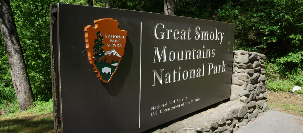 Great Smoky Mountains National Park Sign An engraved sign with surrounding stonework that reads National Park Service, followed by Great Smoky Mountains National Park, National Park Service, U S Department of the Interior.