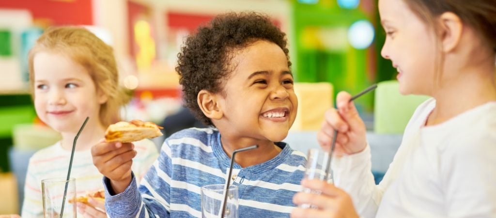 Happy Children Eating Pizza